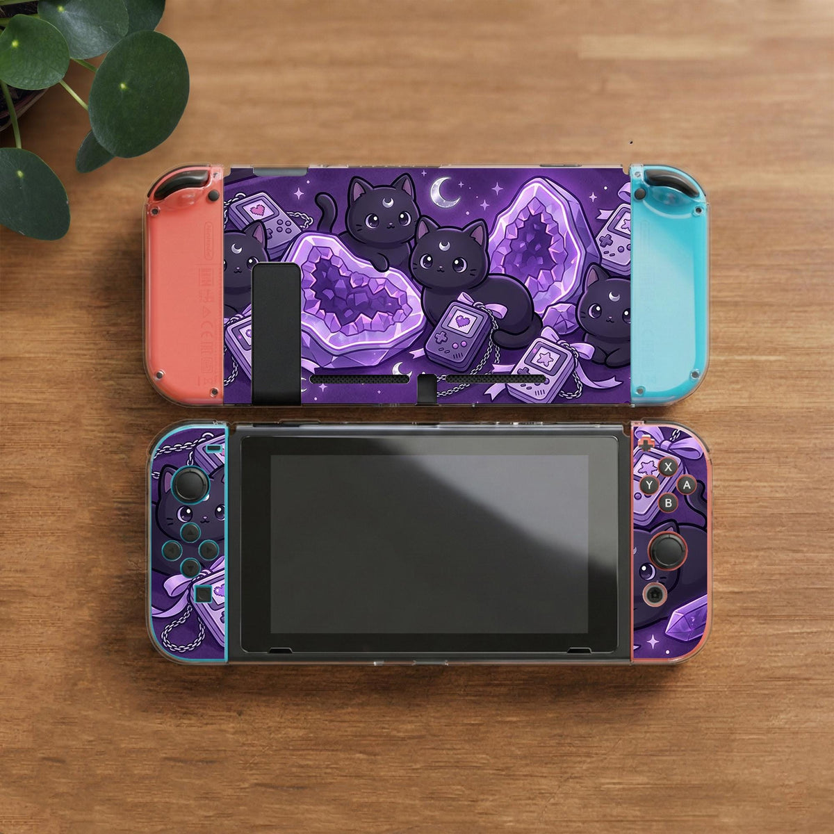 Purple carrying case with black cat faces, moon shapes, stars, and crystal geode style artwork for Nintendo Switch.