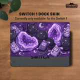 Purple carrying case with black cat faces, moon shapes, stars, and crystal geode style artwork for Nintendo Switch.