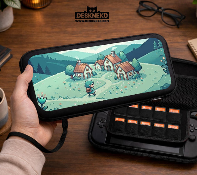 Teal carrying case with a pixel-style village scene, small houses, layered mountains, flowers, and a retro game-inspired landscape design.
