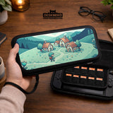 Teal carrying case with a pixel-style village scene, small houses, layered mountains, flowers, and a retro game-inspired landscape design.