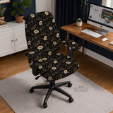 Black chair cover with a moth, moon, and flower pattern in gold, ivory, and dark botanical tones.