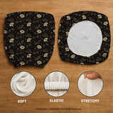 Black chair cover with a moth, moon, and flower pattern in gold, ivory, and dark botanical tones.