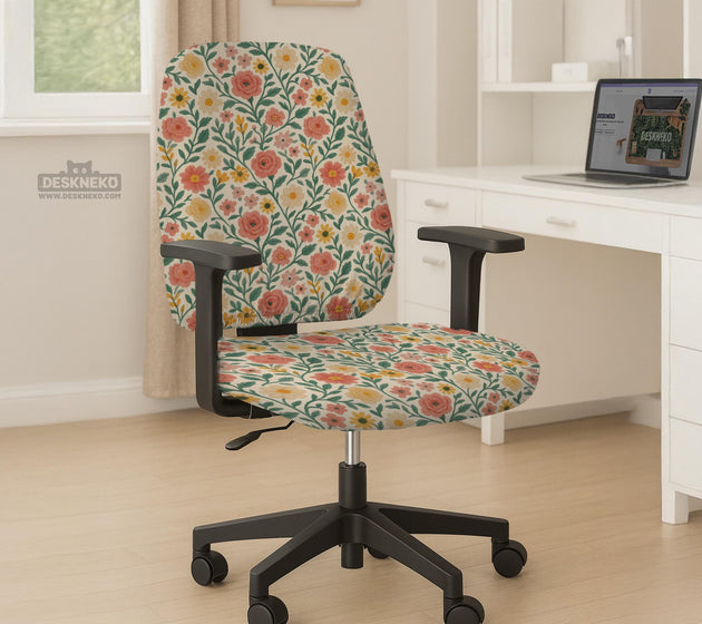 Cream desk chair cover with a vintage floral print featuring coral roses, mustard daisies, and green vines on a chair.