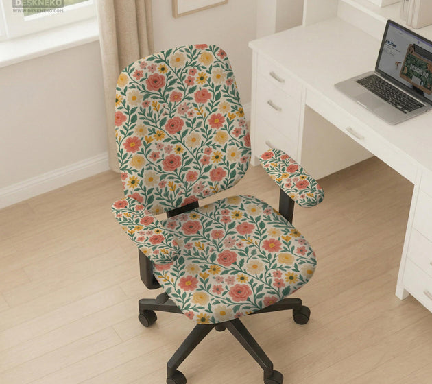Cream desk chair cover with a vintage floral print featuring coral roses, mustard daisies, and green vines on a chair.
