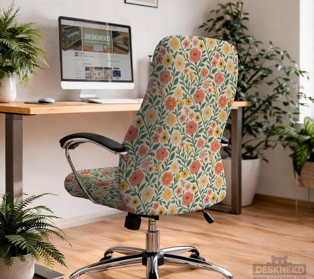 Cream desk chair cover with a vintage floral print featuring coral roses, mustard daisies, and green vines on a chair.