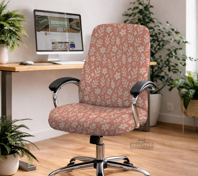 Pink chair cover with a botanical floral print shown on an office chair, with matching armrest covers and multiple cover style options.