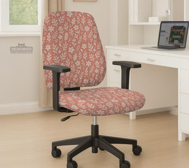 Pink chair cover with a botanical floral print shown on an office chair, with matching armrest covers and multiple cover style options.