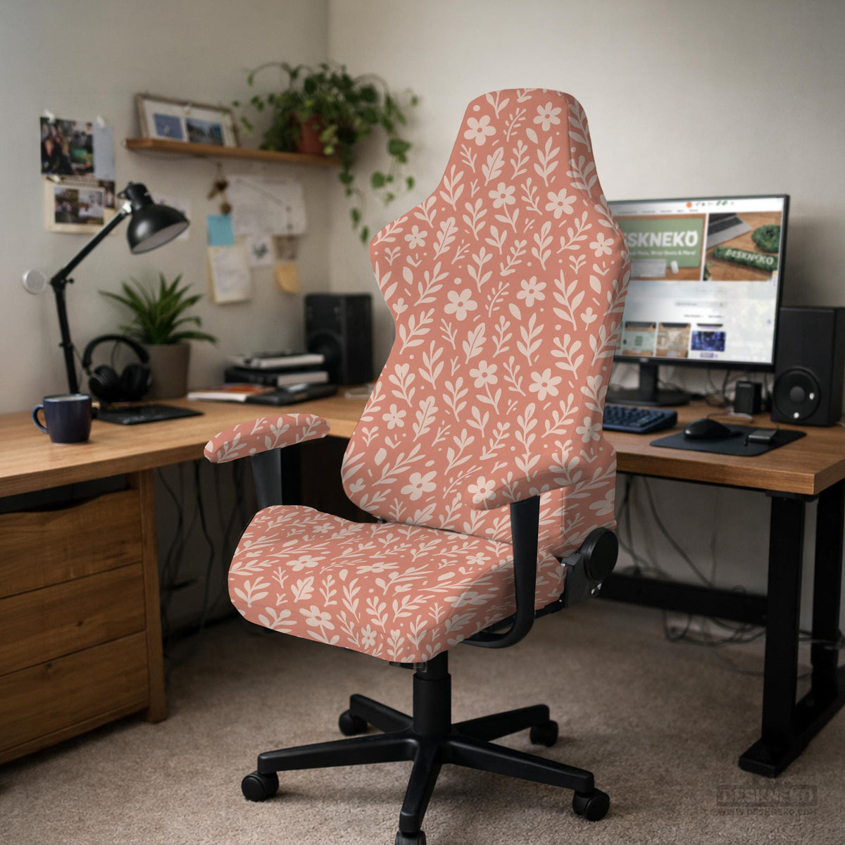 Pink chair cover with a botanical floral print shown on an office chair, with matching armrest covers and multiple cover style options.