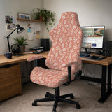 Pink chair cover with a botanical floral print shown on an office chair, with matching armrest covers and multiple cover style options.