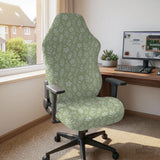 Green chair cover with a small botanical floral print in sage and cream.