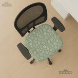 Sage green desk chair cover with a small floral and leaf print shown on an office chair.