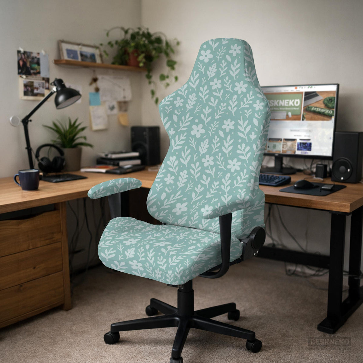 Mint and white botanical desk chair cover with a floral leaf pattern shown on an office chair.