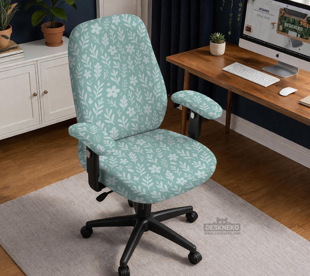 Mint and white botanical desk chair cover with a floral leaf pattern shown on an office chair.