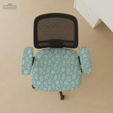 Sage and aqua green floral chair cover shown on a gaming chair with matching armrest covers.