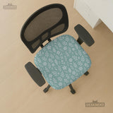 Mint and white botanical desk chair cover with a floral leaf pattern shown on an office chair.