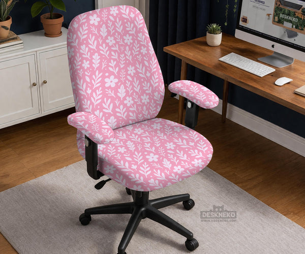 Soft pink floral chair cover shown on a gaming chair with a high back and armrests.