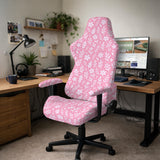 Blush pink chair cover with a small botanical floral pattern shown on an office chair.
