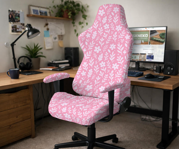 Soft pink floral chair cover shown on a gaming chair with a high back and armrests.