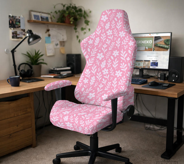 Soft pink floral chair cover shown on a gaming chair with a high back and armrests.