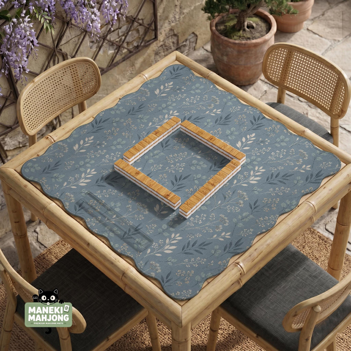 Blue mahjong mat with a dusty linen-look background and small leafy botanical stems in a floral pattern.