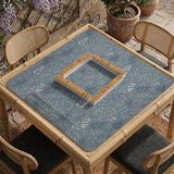 Blue mahjong mat with a dusty linen-look background and small leafy botanical stems in a floral pattern.
