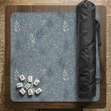 Blue mahjong mat with a dusty linen-look background and small leafy botanical stems in a floral pattern.