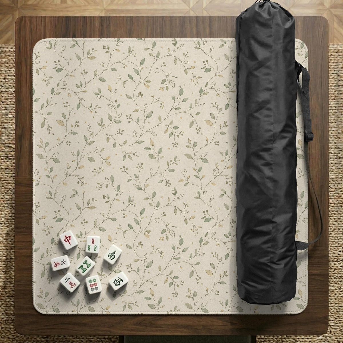 Sage green botanical mahjong mat with a cream background, trailing vines, and muted leaf designs.