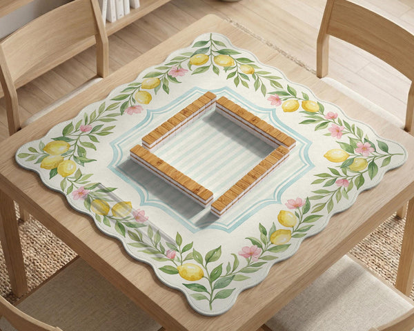 Square yellow mahjong mat with a citrus garden border, green vines, pink blossoms, aqua accents, and a plain center play area.