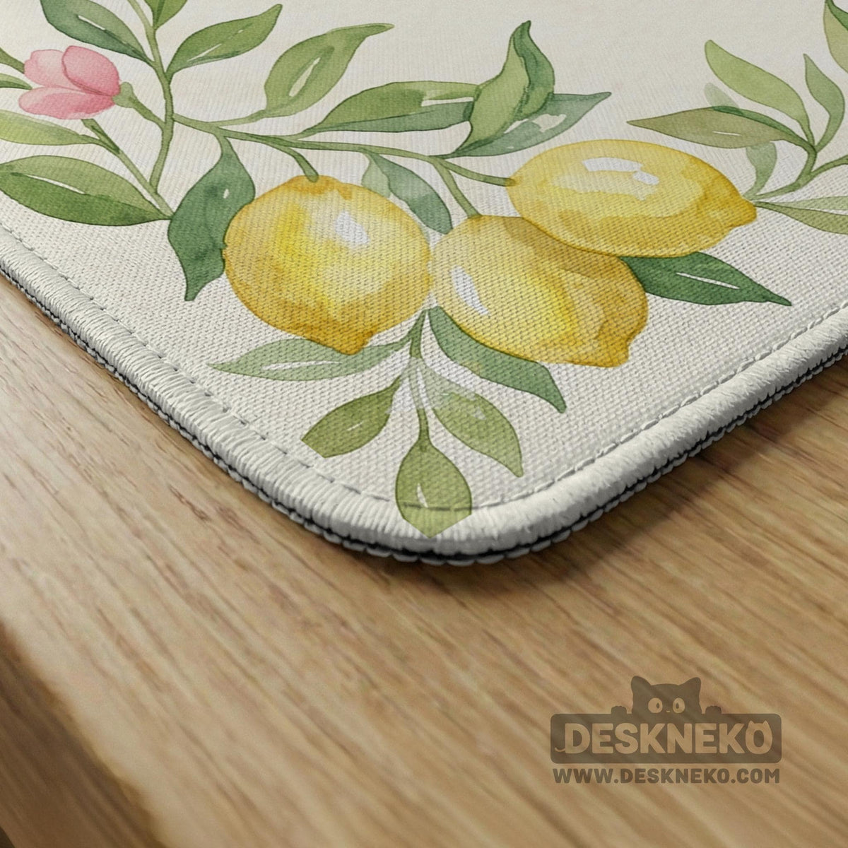 Square yellow mahjong mat with a citrus garden border, green vines, pink blossoms, aqua accents, and a plain center play area.