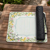 Square yellow mahjong mat with a citrus garden border, green vines, pink blossoms, aqua accents, and a plain center play area.