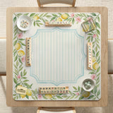 Square yellow mahjong mat with a citrus garden border, green vines, pink blossoms, aqua accents, and a plain center play area.