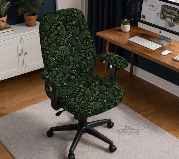Forest green chair cover with a tropical leaf pattern featuring monstera leaves and small cream flowers.