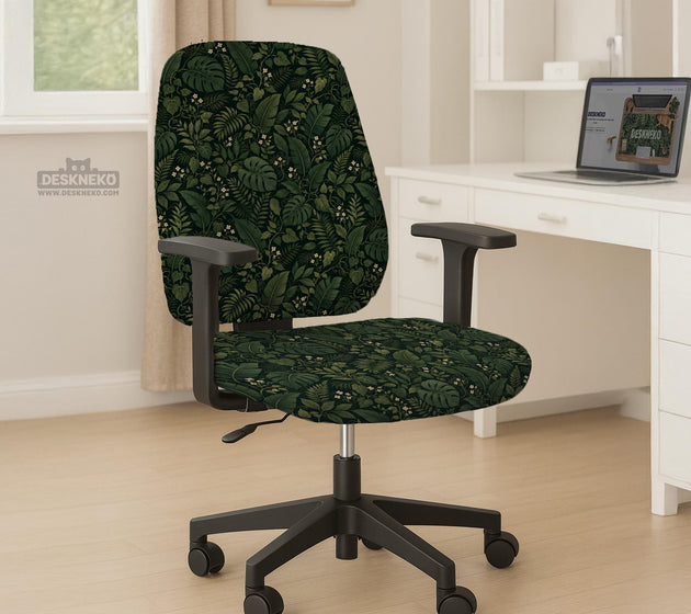 Forest green chair cover with a tropical leaf pattern featuring monstera leaves and small cream flowers.