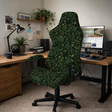 Forest green chair cover with a tropical leaf pattern featuring monstera leaves and small cream flowers.