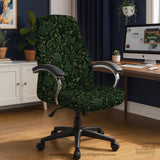 Forest green chair cover with a tropical leaf pattern featuring monstera leaves and small cream flowers.