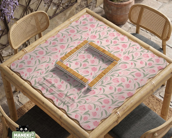 Pink mahjong mat with a tulip floral pattern in blush and sage tones and a scalloped edge.