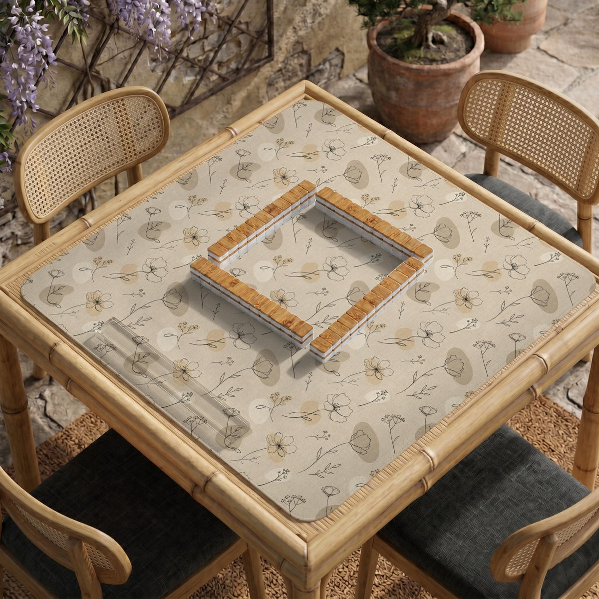 Neutral floral mahjong mat with delicate botanical line art and a scalloped edge on a cream background.