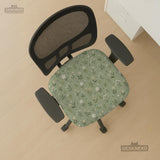 Green chair cover with a sage floral botanical print shown on a high-back gaming chair and office chair.
