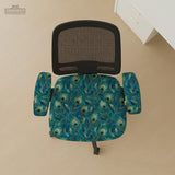 A blue green chair cover with a peacock feather design shown on an office chair with armrests.