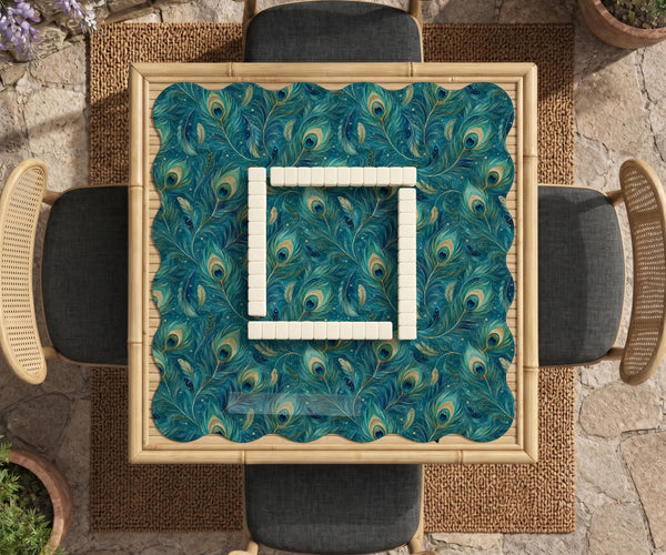 A teal mahjong mat with a peacock feather pattern and scalloped edges.
