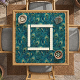 Teal mahjong mat with a peacock feather pattern in blue green tones.