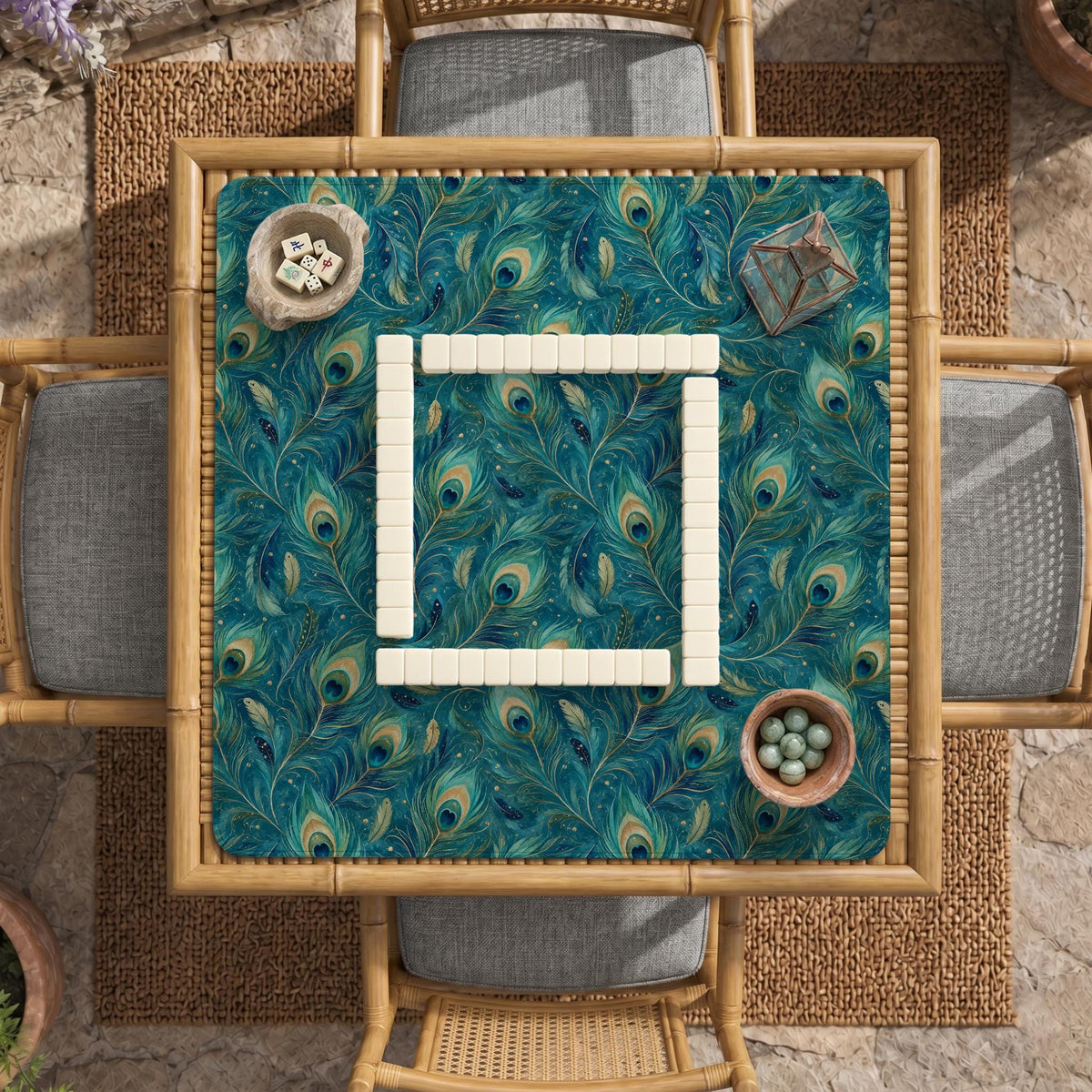 A teal mahjong mat with a peacock feather pattern and scalloped edges.