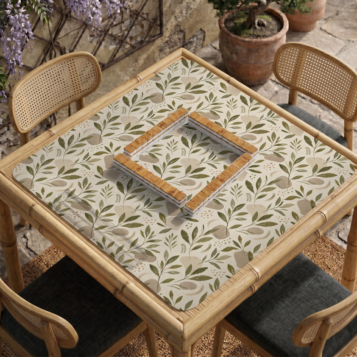Green botanical mahjong mat with sage leaf and floral design and a scalloped edge.