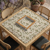 Green botanical mahjong mat with sage leaf and floral design and a scalloped edge.
