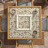 Green botanical mahjong mat with sage leaf and floral design and a scalloped edge.