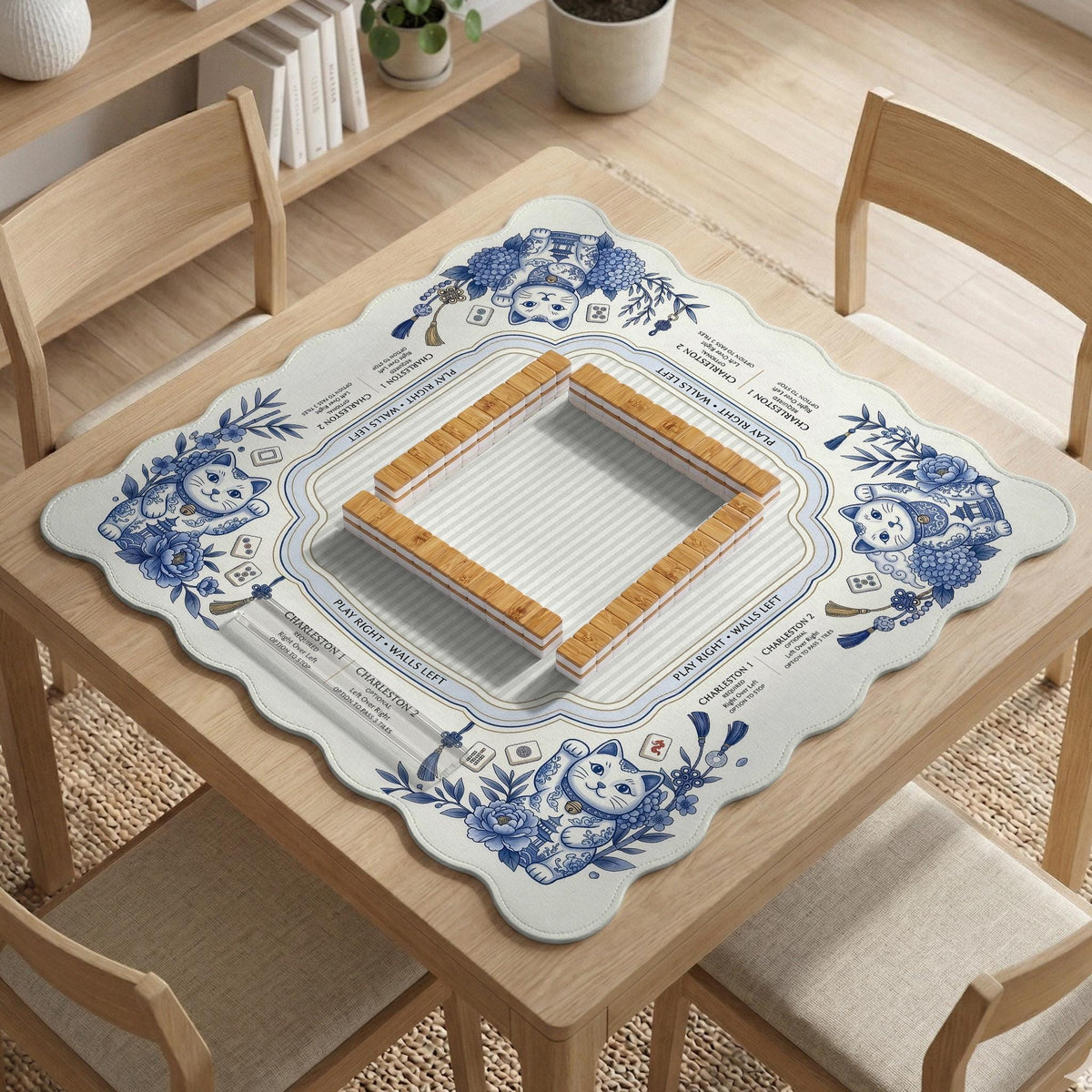 Blue and white square mahjong mat with lucky cat artwork, floral chinoiserie pattern, tile icons, and a rule guide layout.
