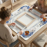 Blue and white square mahjong mat with lucky cat artwork, floral chinoiserie pattern, tile icons, and a rule guide layout.