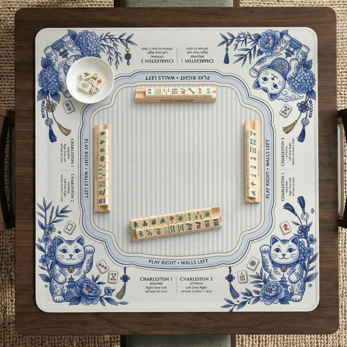 Blue and white square mahjong mat with lucky cat artwork, floral chinoiserie pattern, tile icons, and a rule guide layout.