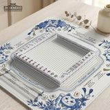 Blue and white square mahjong mat with lucky cat artwork, floral chinoiserie pattern, tile icons, and a rule guide layout.