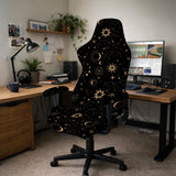Black chair cover with a gold astrology print of moons, suns, stars, and symbols on a gaming chair.